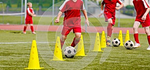 Soccer camp for kids. Boys practice dribbling in a field. Players develop good soccer dribbling skills photo