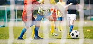 Soccer for children. Kids compete in outdoor soccer game. European football tournament match between school age boys