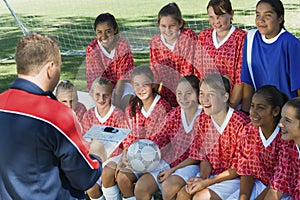 Soccer Coach Explaining Strategy To Team