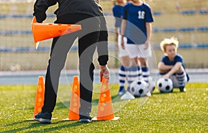 Soccer Coach Placing Training Cones for Kids Sports Team. Children on Soccer Football Class photo
