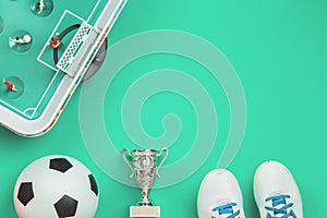 Soccer concept with football table game, cup and ball