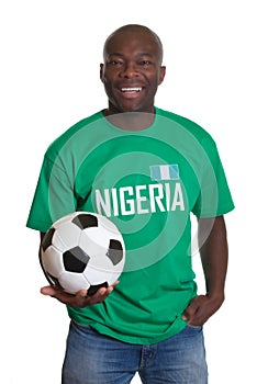 Soccer fan from Nigeria with ball looking at camera