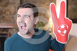 Soccer fan wearing victory sign foam glove