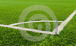 Soccer field corner line on green grass.