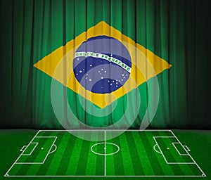 Soccer field with flag of Brazil on green curtain