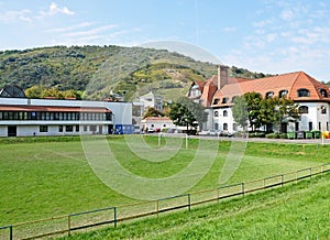 Soccer field nex to an elementary school building