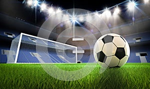 Soccer or football ball on field with soccer stadium background