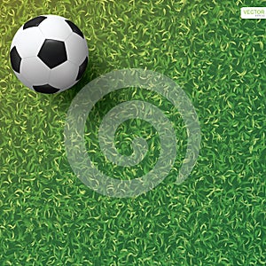 Soccer football ball on green grass field background. Vector.