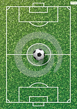 Soccer football ball on green grass of soccer field with line pattern.