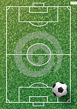 Soccer football ball on green grass of soccer field with line pattern.