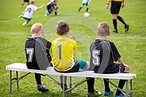 Soccer Football Bench. Young Footballers Sitting on Football Substitute Bench.