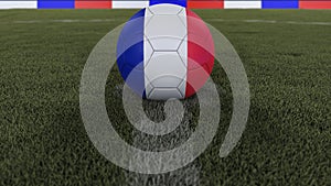 Soccer / football classic ball in the center of the field grass with painting of the France flag with depth of field defocused, 3D