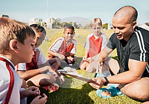 Soccer, football coach with team talk and strategy with tactics winning game sitting on grass training field. Boy