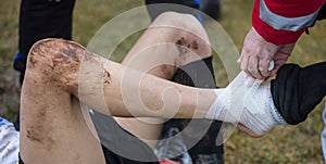 Soccer, football concept. Injured footballer lay down on field with hurting ankle. Blurred background, close up view.