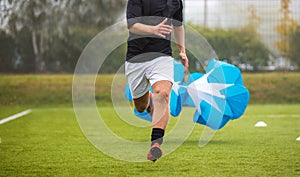 Soccer Football Endurance Training. Speed or Sprint Testing with Parachute. Professional Soccer Strength Test photo