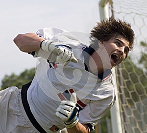 Soccer Football Goal Keeper straining for Save