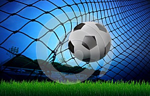 Soccer football in goal net and stadium blue sky b