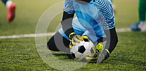 Soccer Football Goalkeeper Catching Ball. Goalie in Action on the Pitch During Match