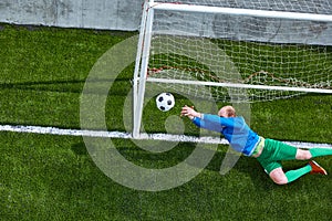 Soccer football goalkeeper making diving save