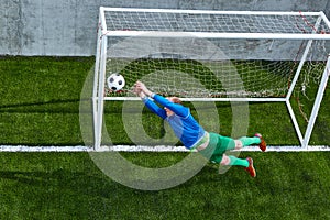 Soccer football goalkeeper making diving save