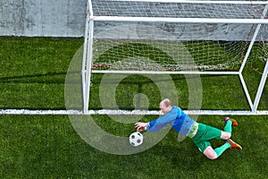 Soccer football goalkeeper making diving save