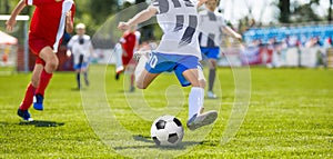 Soccer Football Kick. Young Player Kicking Soccer Ball. Footballers Running the Ball