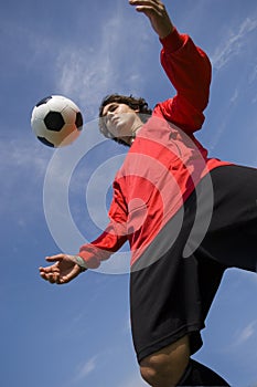 Soccer Football Player in red controlling ball