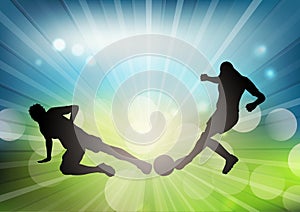 Soccer or football player silhouettes on defocussed background photo