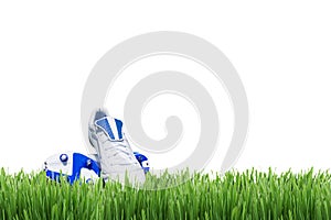 Soccer or football shoes on green grass isolated on white background