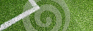 Soccer football sport background. Green synthetic artificial grass soccer sports field with white corner stripe line