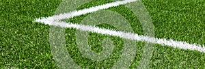 Soccer football sport background. Green synthetic artificial grass soccer sports field with white corner stripe line