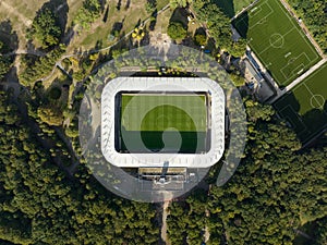 Soccer football stadium top down overhead Aerial in forrest park. Green grass landmark landscape architecture structure