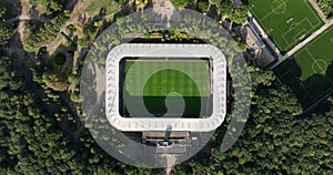 Soccer football stadium top down overhead Aerial in forrest park. Green grass landmark landscape architecture structure