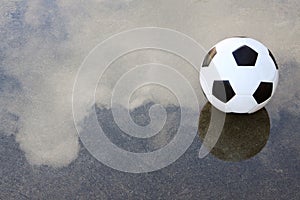 Soccer football on wet ground