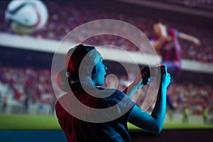 Soccer game, girl gamer playing a game in football headphones on a big screen, with bright light and a dark room. Gameplay,