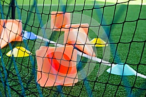 Soccer goal and cones on green artificial turf