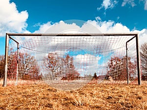 Soccer goal on countryside, low angle view of rural soccer field