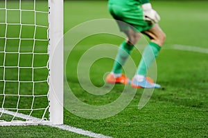 Soccer goal with goalkeeper in background