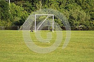 SOCCER GOAL IN A GRASS FIELD ON A SUNNY DAY