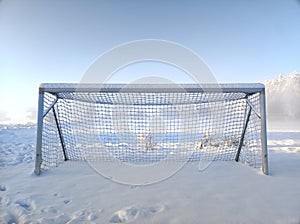 Soccer goal in picturesque winter scenery covered in deep snow