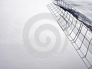 Soccer goal and pitch under snow in winter