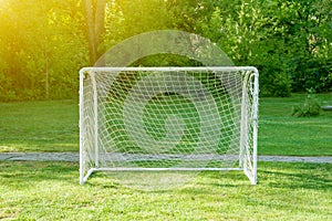 Soccer goal with soccer field green grass sunny day.