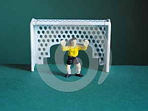 Soccer goalkeeper, dressed in yellow. Game strategy