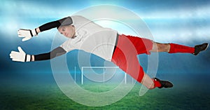 Soccer goalkeeper saving near goal