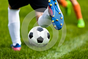 Soccer Kick. Footballer Kicking Ball on Grass Pitch. Football Soccer Player Hits a Ball photo