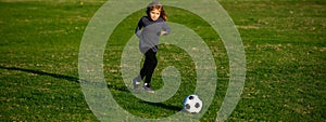 Soccer kid. Kids play football on summer stadium field. Little child boy kicking ball. Football sport training for