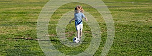 Soccer kid. Kids play football on summer stadium field. Little child boy kicking ball. Football sport training for