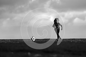 Soccer kid. Kids play football on summer stadium field. Little child boy kicking ball. Football sport training for