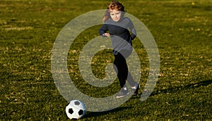 Soccer kid. Kids play football on summer stadium field. Little child boy kicking ball. Football sport training for