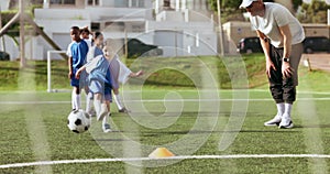 Soccer, kids kicking and training for game and sport drill for workout and exercise on a school field. Students